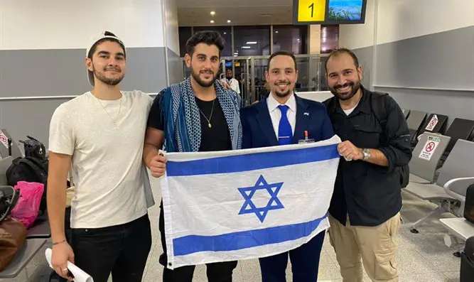 The three who were freed, with the Israeli representative 