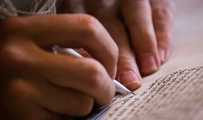 Scribe writes a Torah scroll