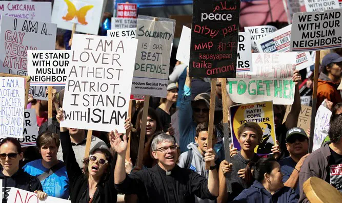 Counter-protesters hold signs and shout slogans during an anti-Sharia rally in Seattle