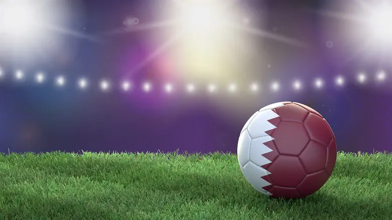 Soccer ball colored like Qatari flag, on a field