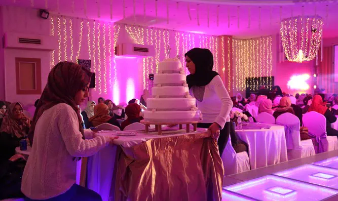 Serving cake during wedding party at hotel in Gaza City