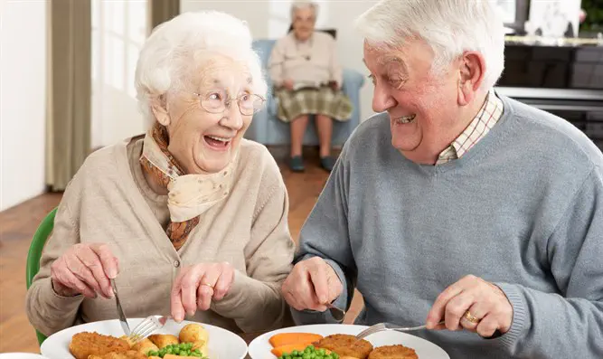 Senior citizens enjoy a meal together