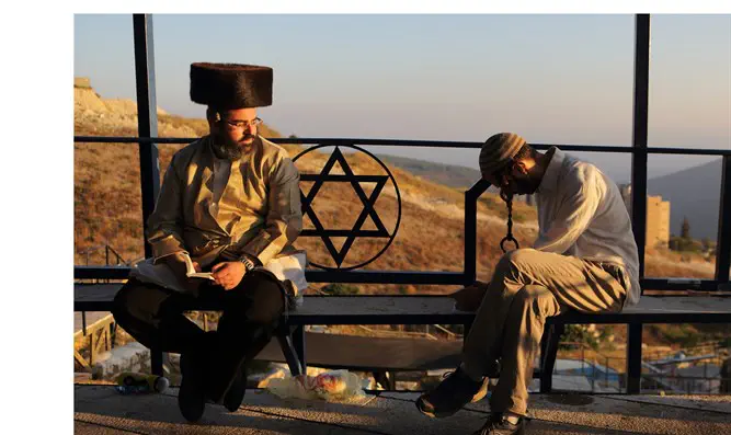 Religious Jews sit near the Ari'zal's tomb, Tzfat
